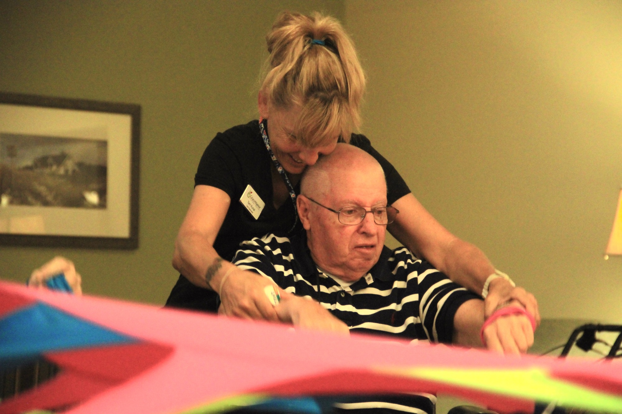 Terry Kunai, lead care specialist, helps Doug Switzer with exercises. Photo by Nichole Osinski