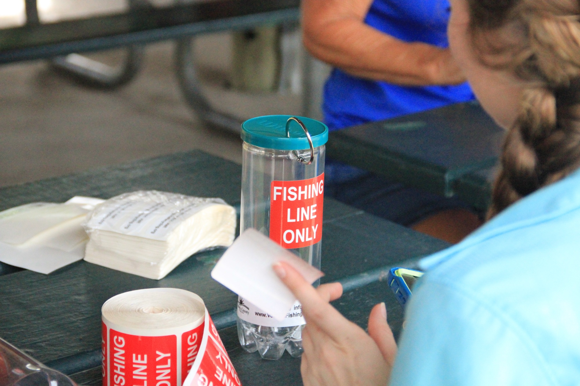 Jennifer Cherry put labels on bins. Photo by Nichole Osinski