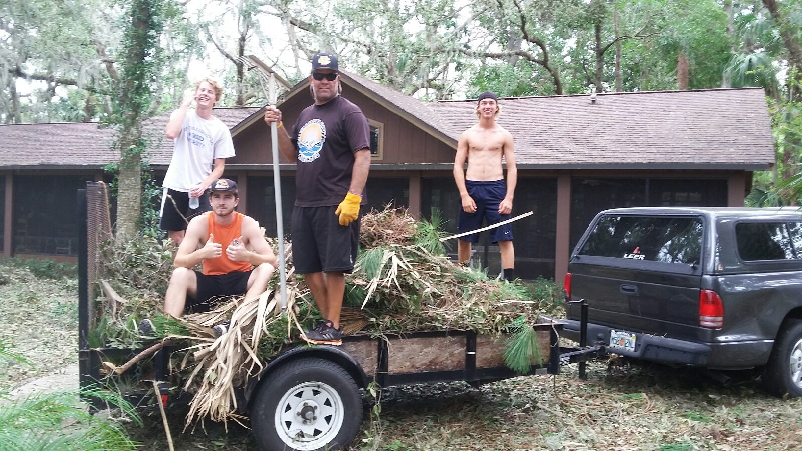 Members of the Spruce Creek baseball team help with storm debris cleanup. Photo courtesy of Lee McFarland