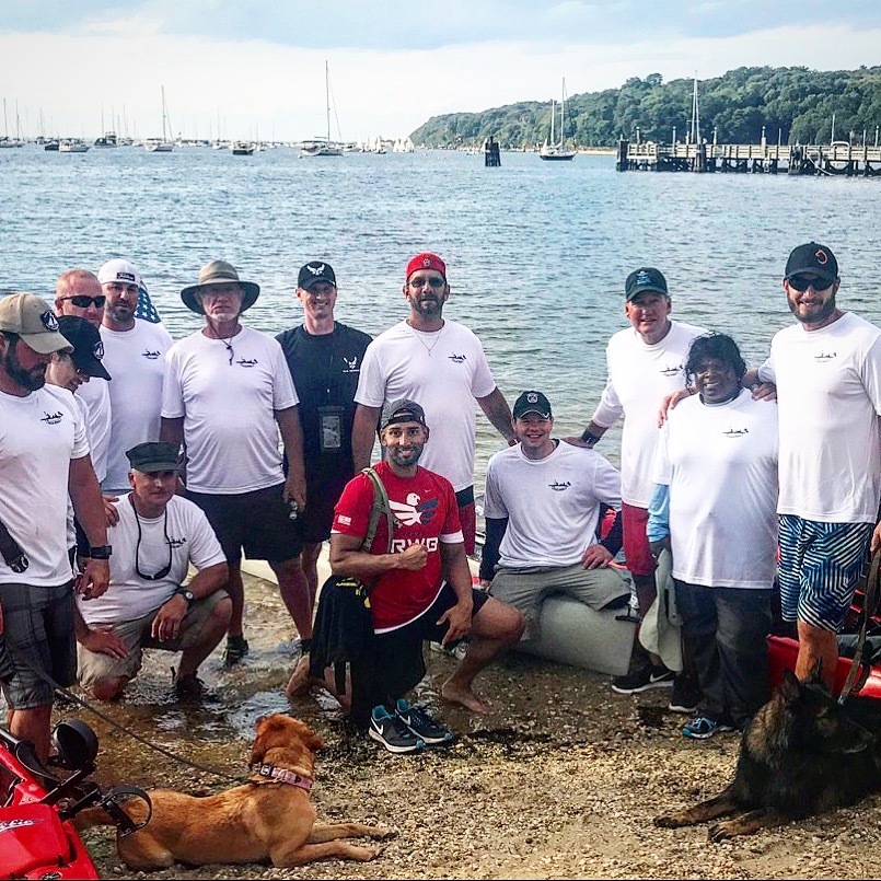 Aaron Tucker poses for a photo with a group of veterans and participants of the kayak trip. Photo courtesy of Aaron Tucker