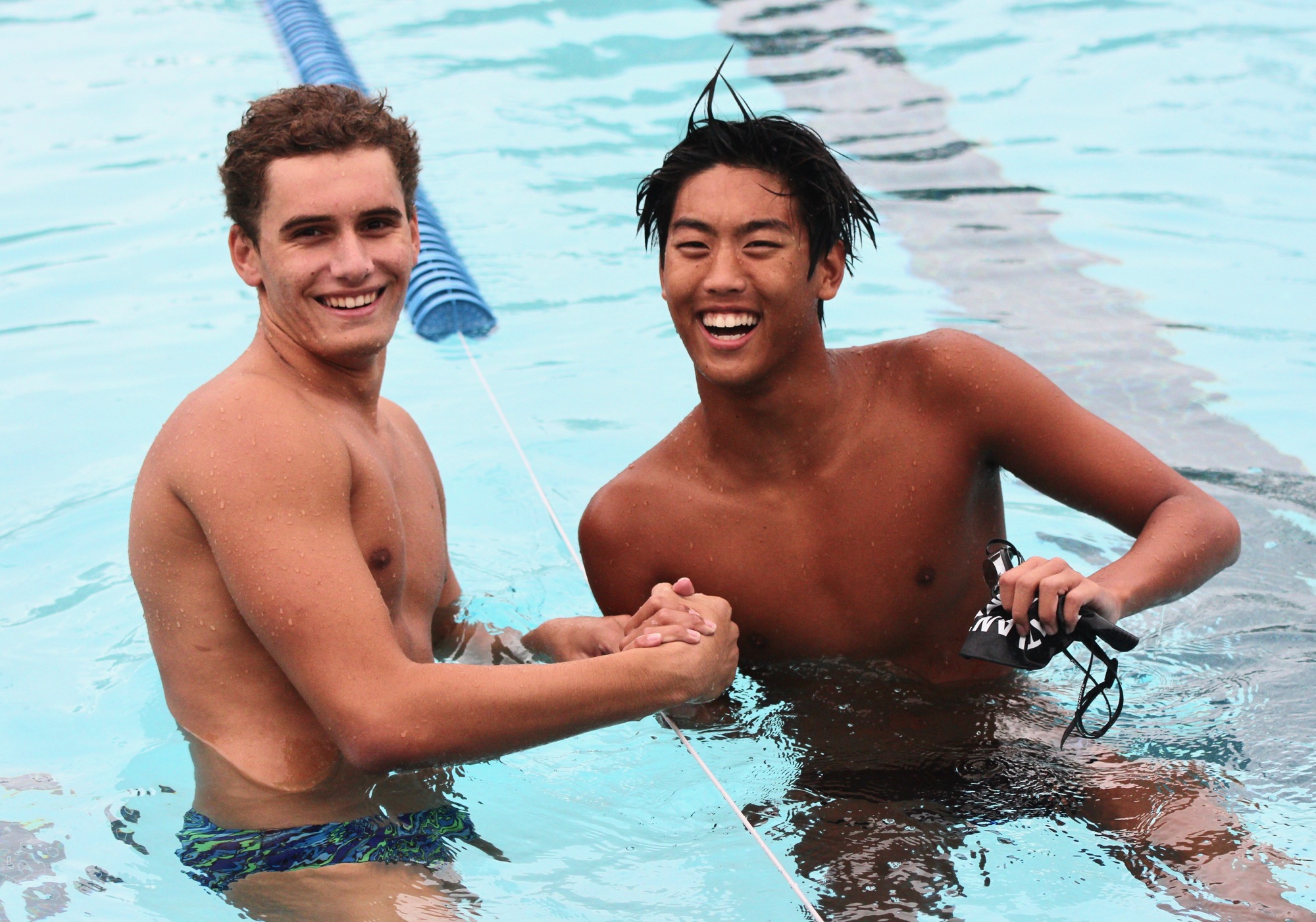 Sharks swimmer Joseph Yim (right) shakes hands with Matanzas swimmer Brendan Zagumennikh after Yim's win in the 100-meter butterfly. Photo by Ray Boone