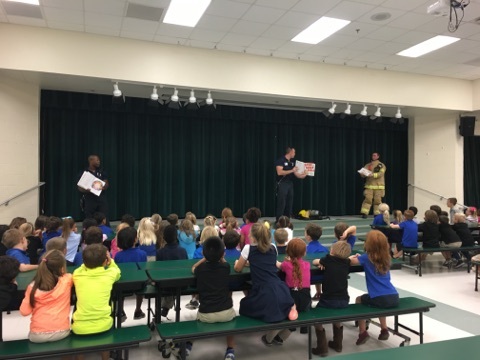 Firefighters talk with Cypress Creek Elementary students about fire safety. Photo courtesy of Port Orange Fire and Rescue