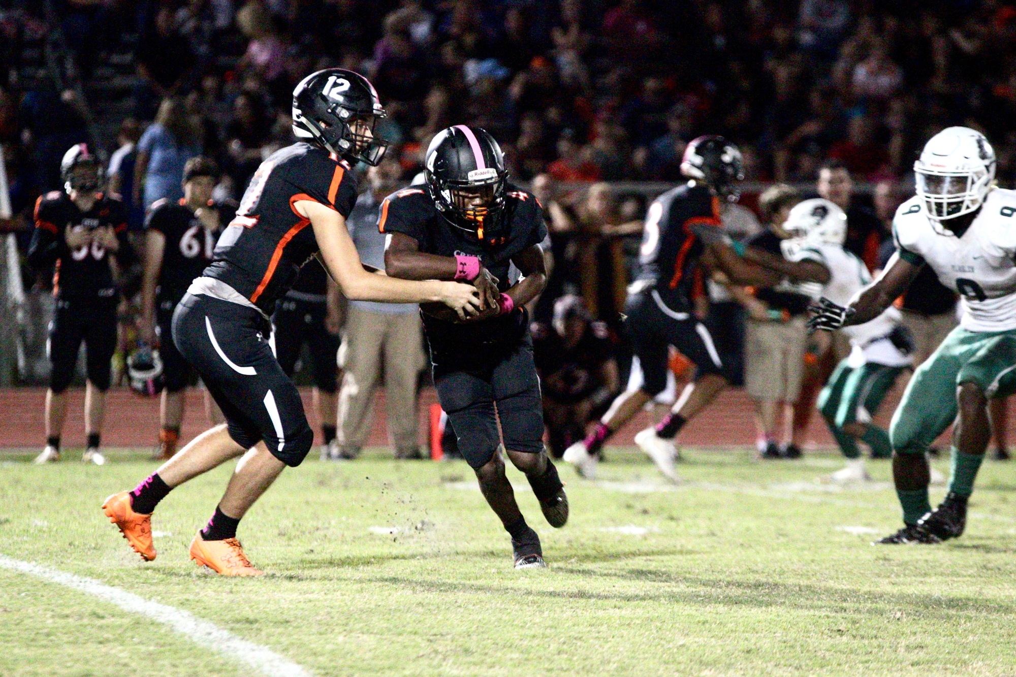 Spruce Creek running back Jacquez Lord takes a hand-off from Hawks quarterback Kyle Minckler in a game against Flagler Palm Coast on Friday, Oct. 13. Photo by Ray Boone