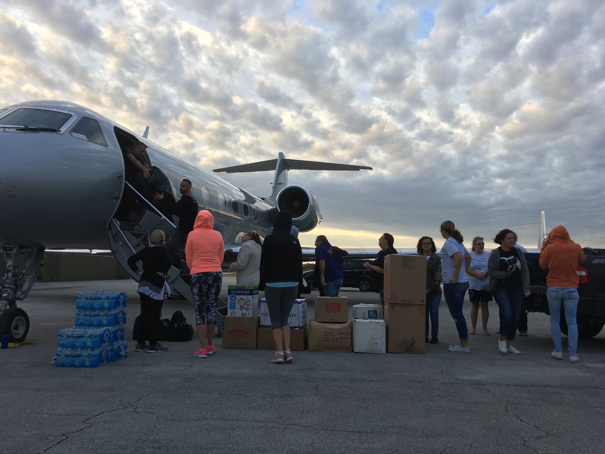 Volunteers form a line to unload donated goods. Photo by Nichole Osinski