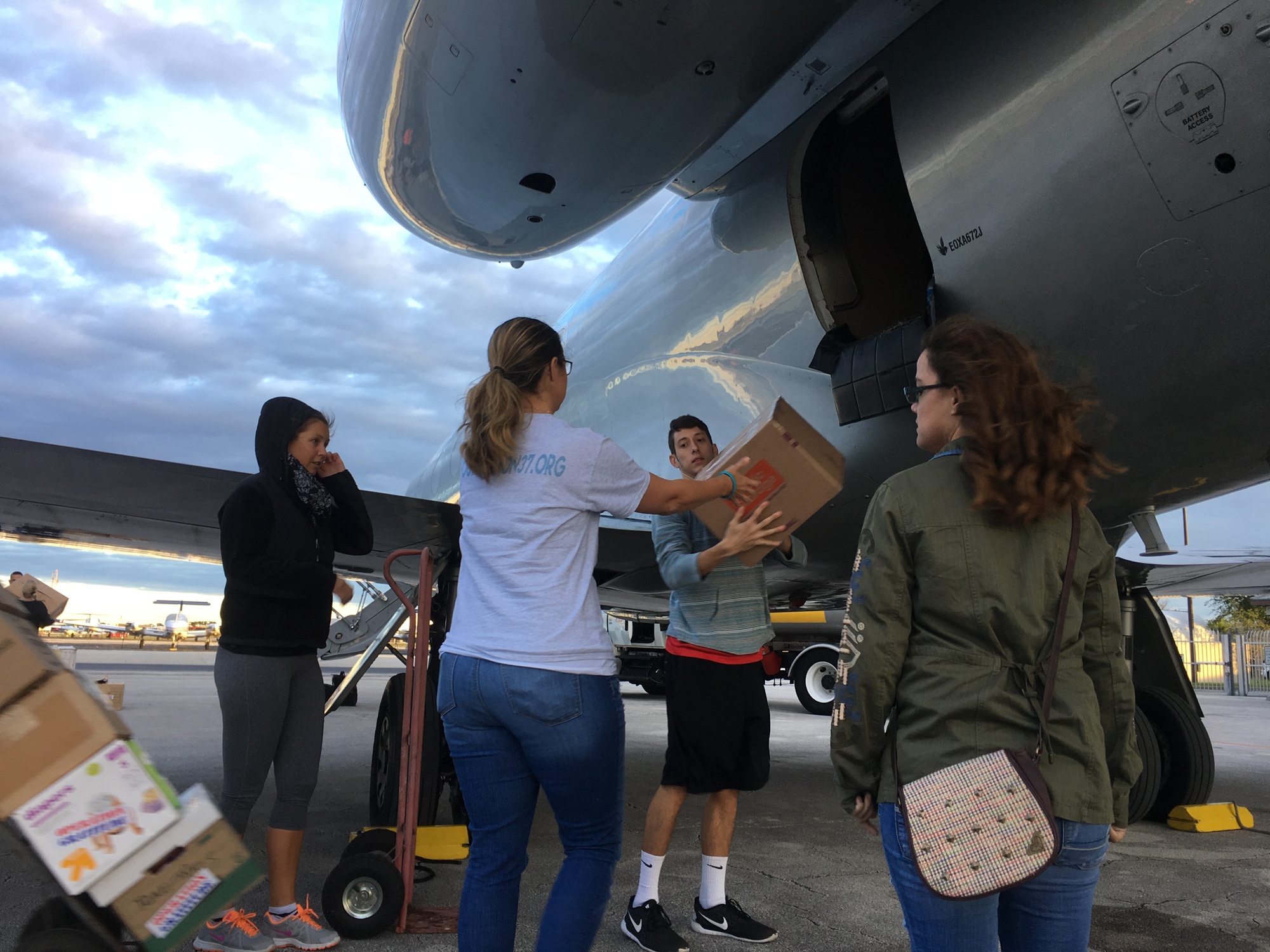 Volunteers unload a plane to help distribute items for hurricane relief efforts. Photo by Nichole Osinski