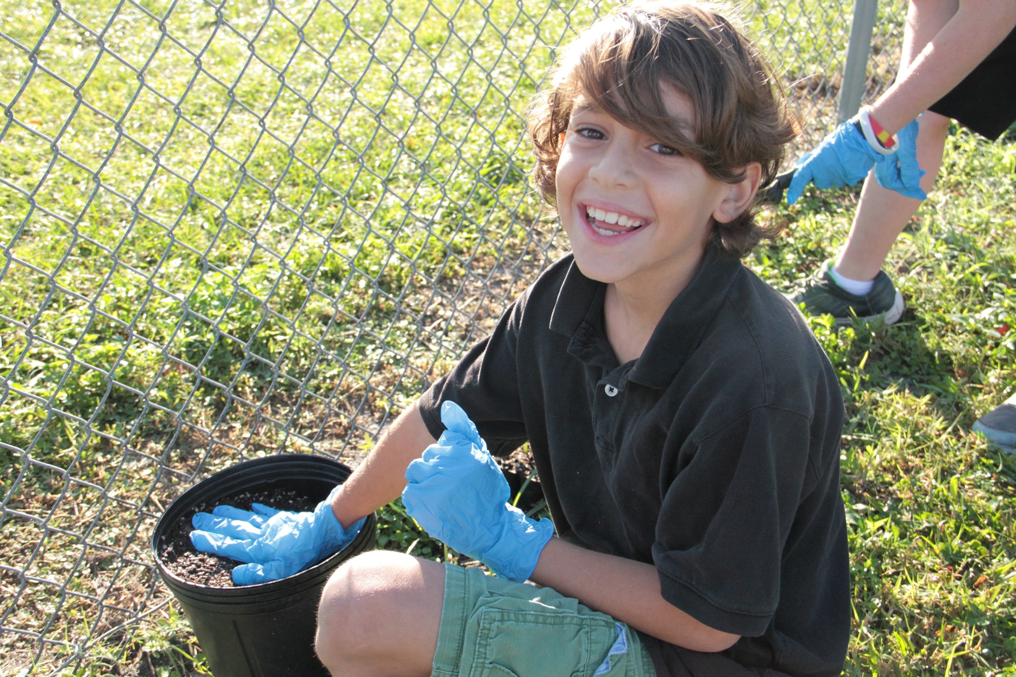 Dominic Arroyo helps in the Sugar Mill garden. Photo by Nichole Osinski