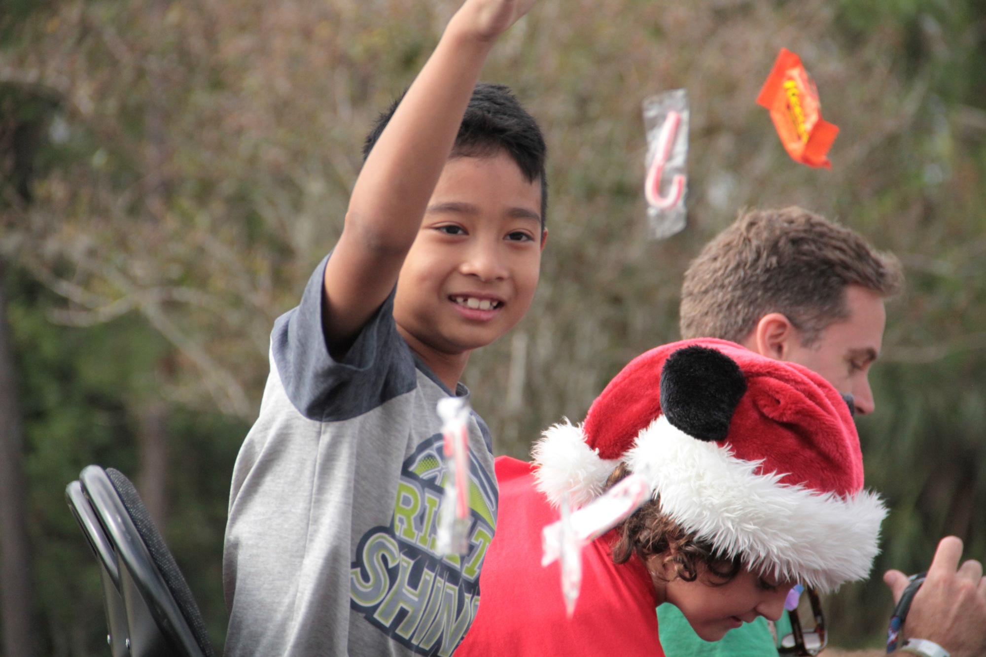 A child throws candy for the crowd during the parade. Photo by Nichole Osinski