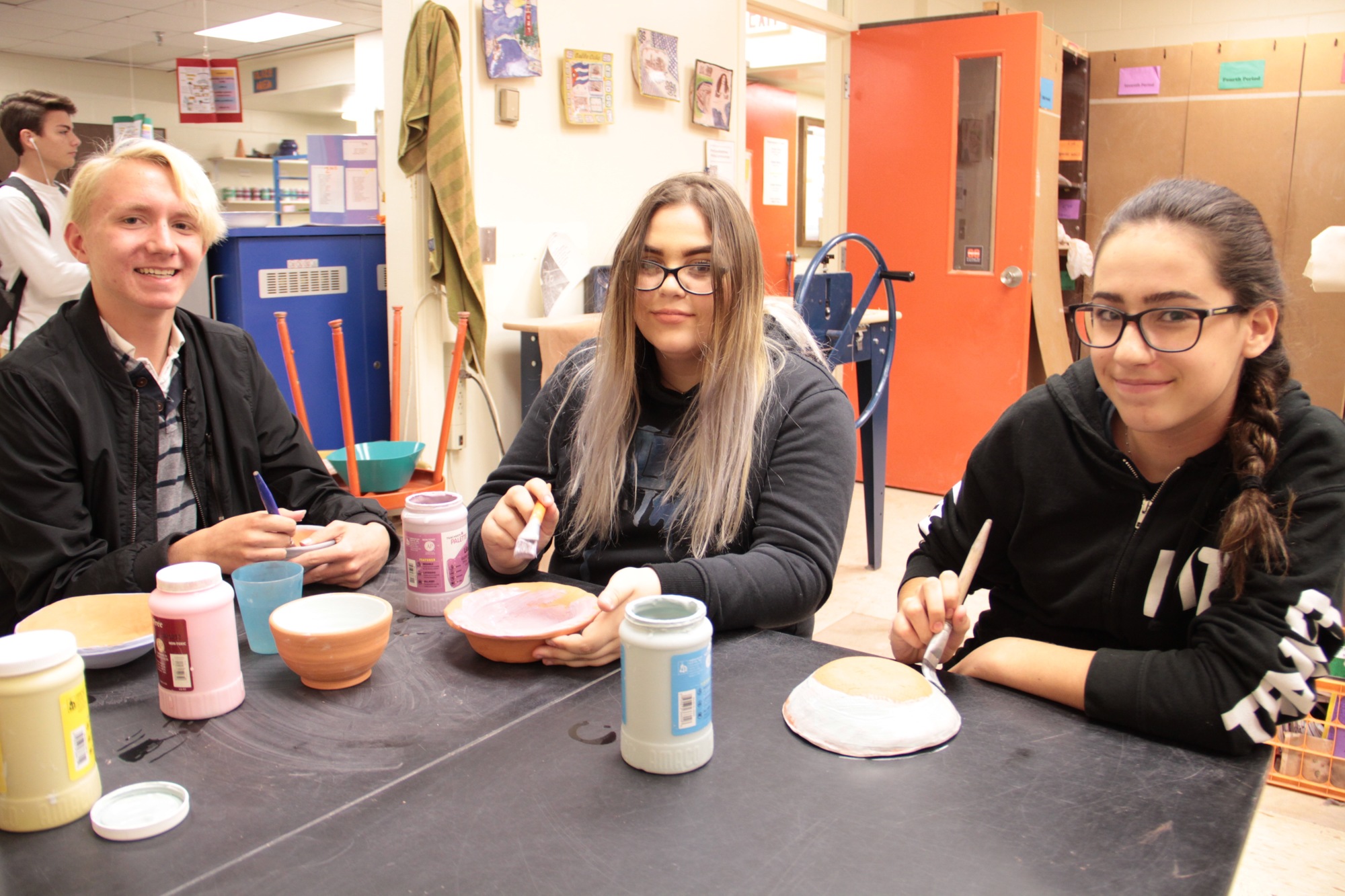 Matthew Jefferson, Kaylei Anabatykefer and Aria Paoletti work on bowls for the Empty Bowls event. Photo by Nichole Osinski