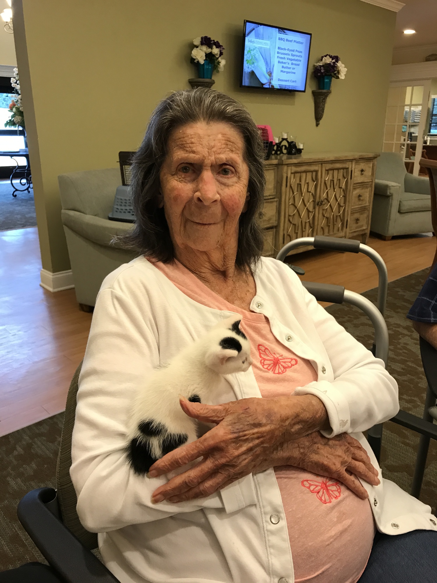 A resident at an assisted living facility holds a cat used for pet therapy. Photo courtesy of Jan Wenger