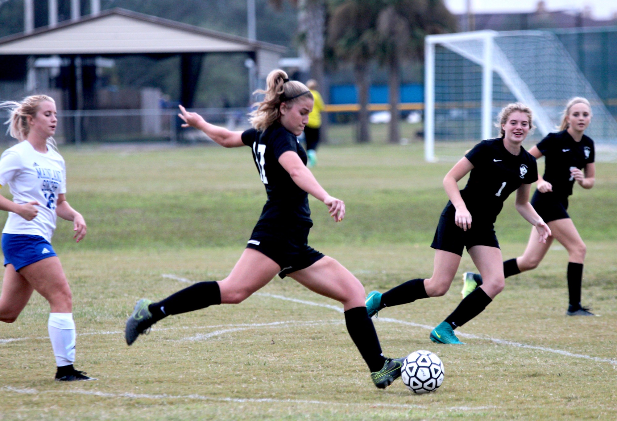 Spruce Creek's Ally Runge launches a kick against Mainland. Photo by Ray Boone