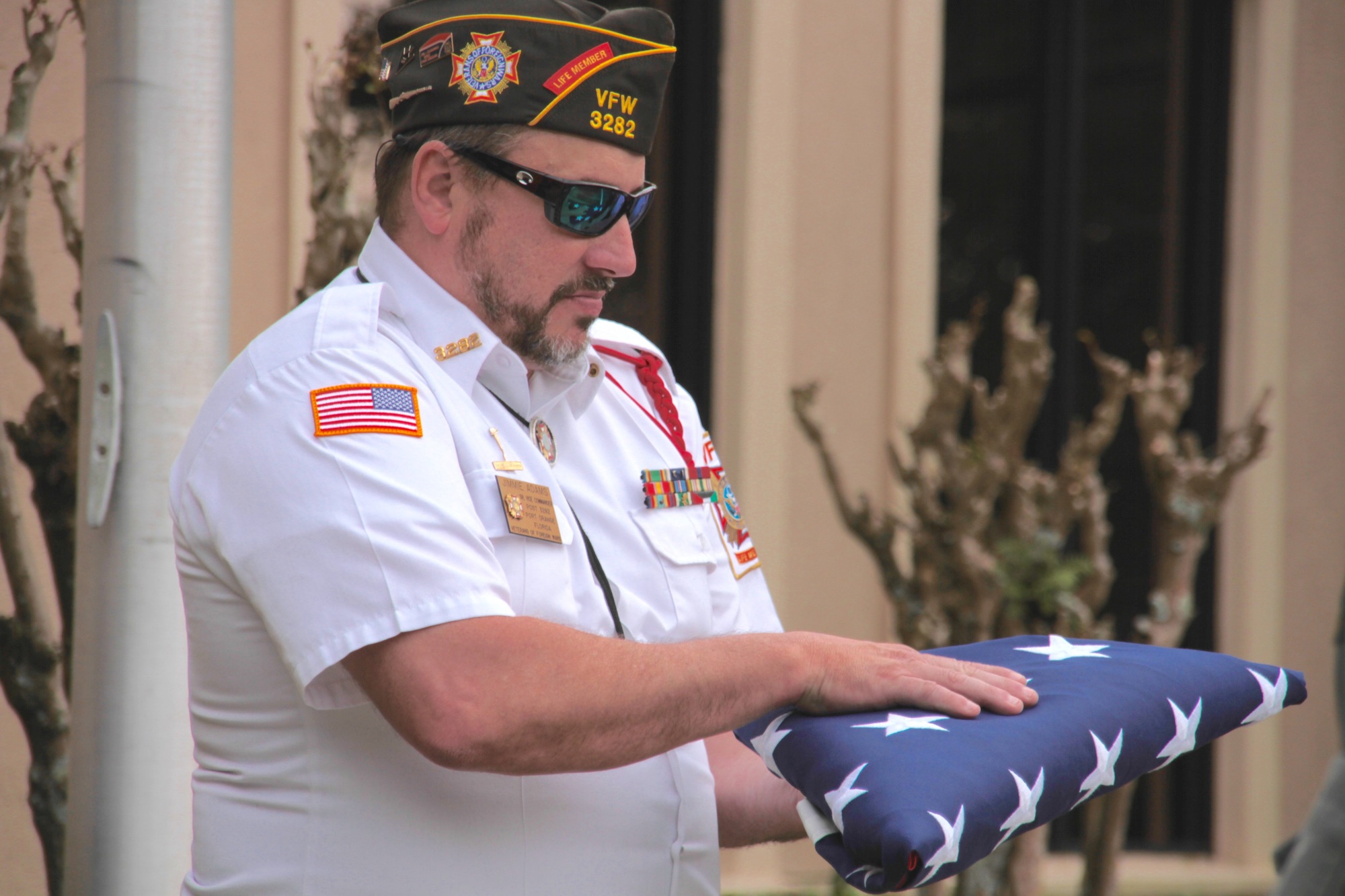 Jimmie Adams carries the flag during the retirement ceremony. Photo by Nichole Osinski