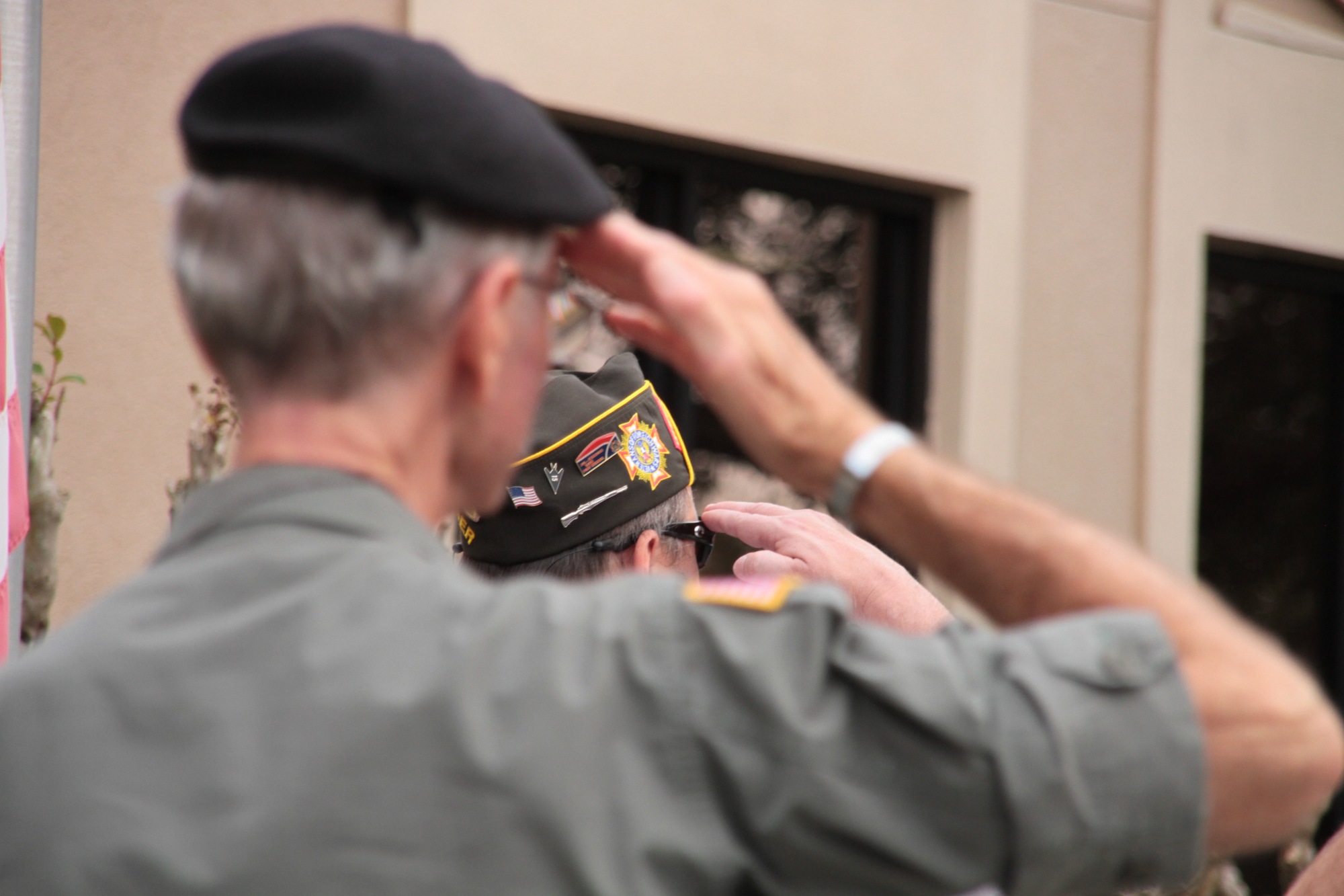 Members of the VFW and Vietnam Veterans of America salute the flag. Photo by Nichole Osinski