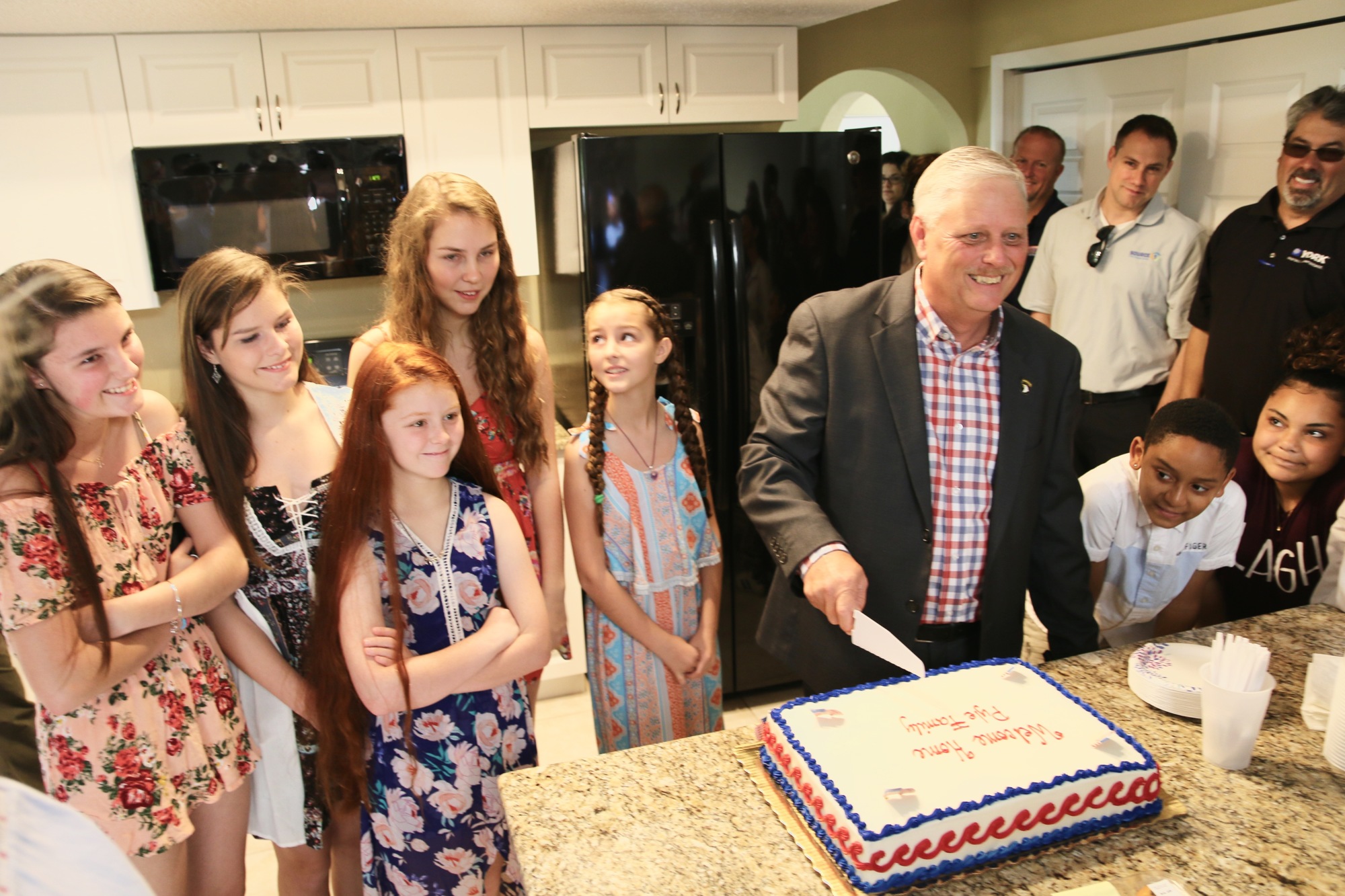 Michaeli, Mandy, Brandi, Chloe and Jessie Pyle watch as their father, Stephen Pyle, cuts the cake. Photo by Nichole Osinski