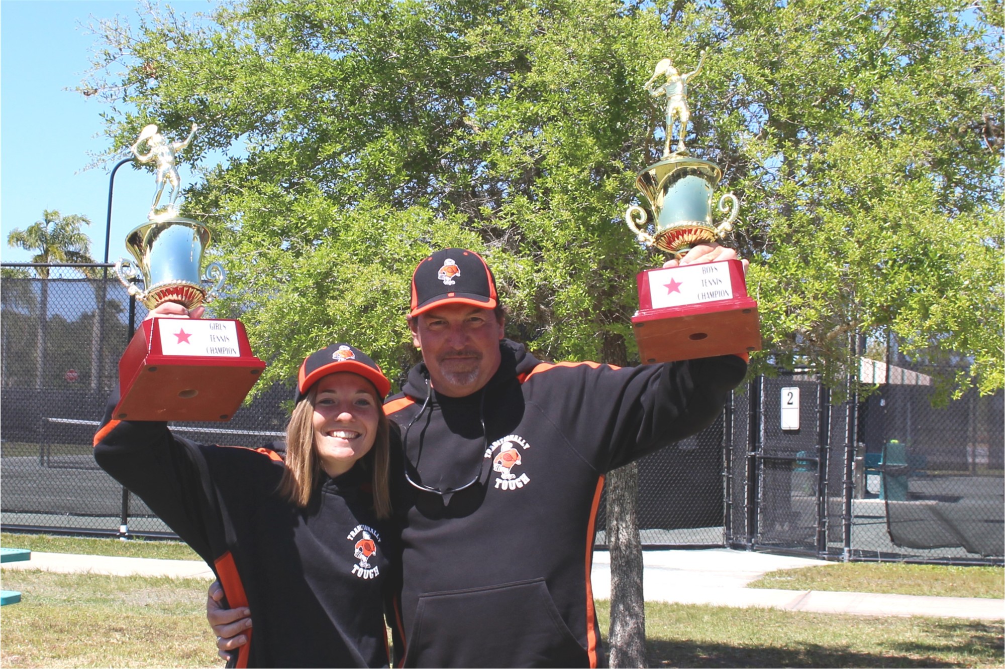 Spruce Creek boys coach Todd Palmer celebrates a conference championship with his daughter Bailey Palmer, the girls coach. Courtesy photo