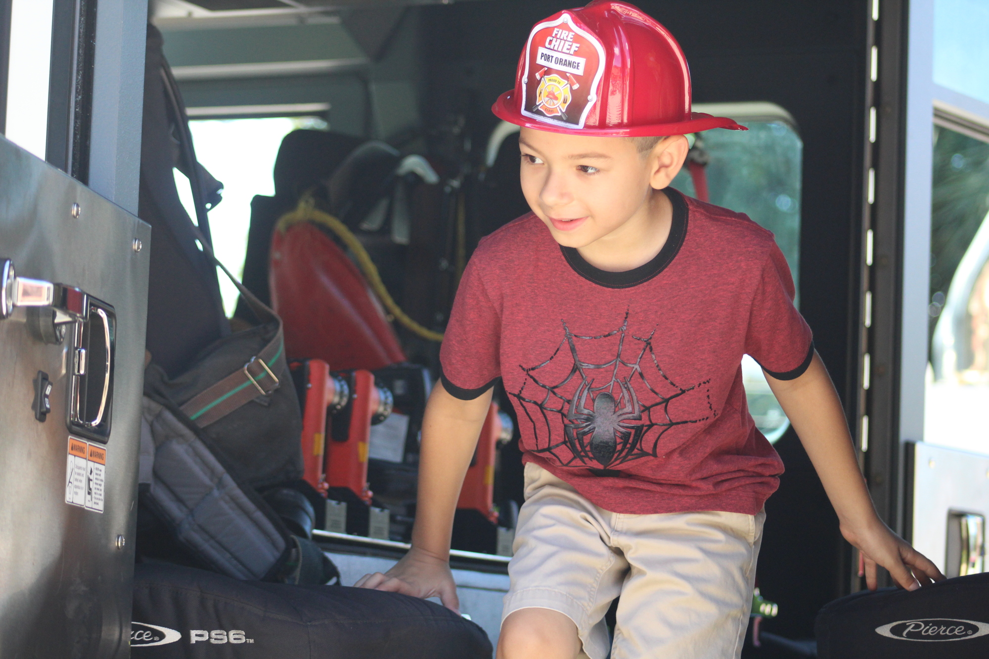 Children climbed into the station's parked fire trucks to get a first-hand look at gear and tools firefighters use when on the go. 