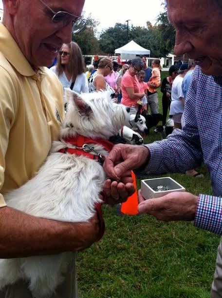 Billie Lynch with his dog Pippa being blessed by retired vet Dr. Brian Smith.