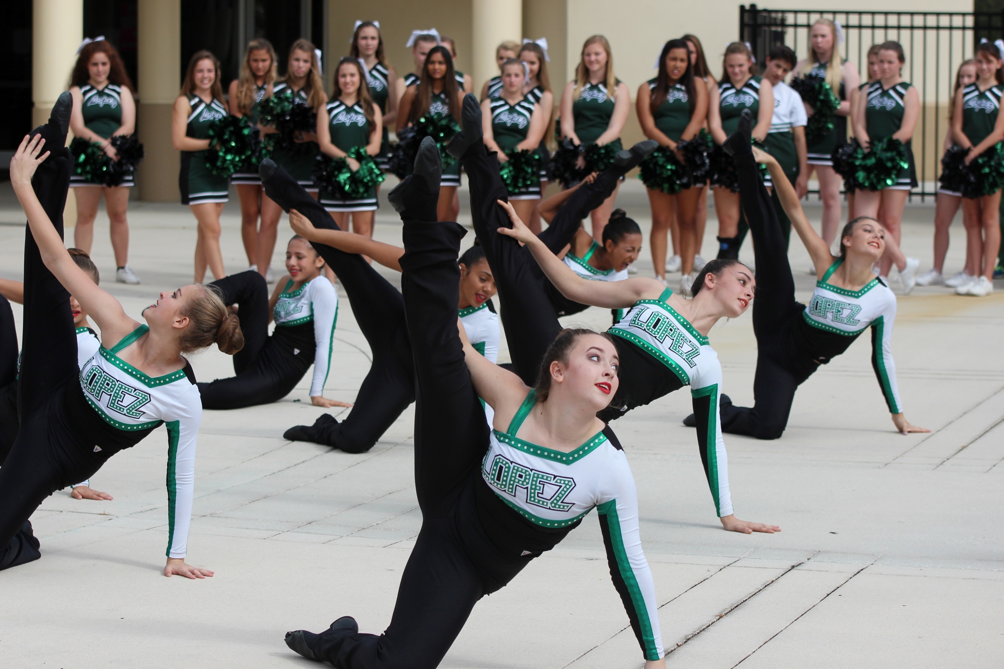 Dancers and cheerleaders perform routines at the cross country's championship pep assembly.