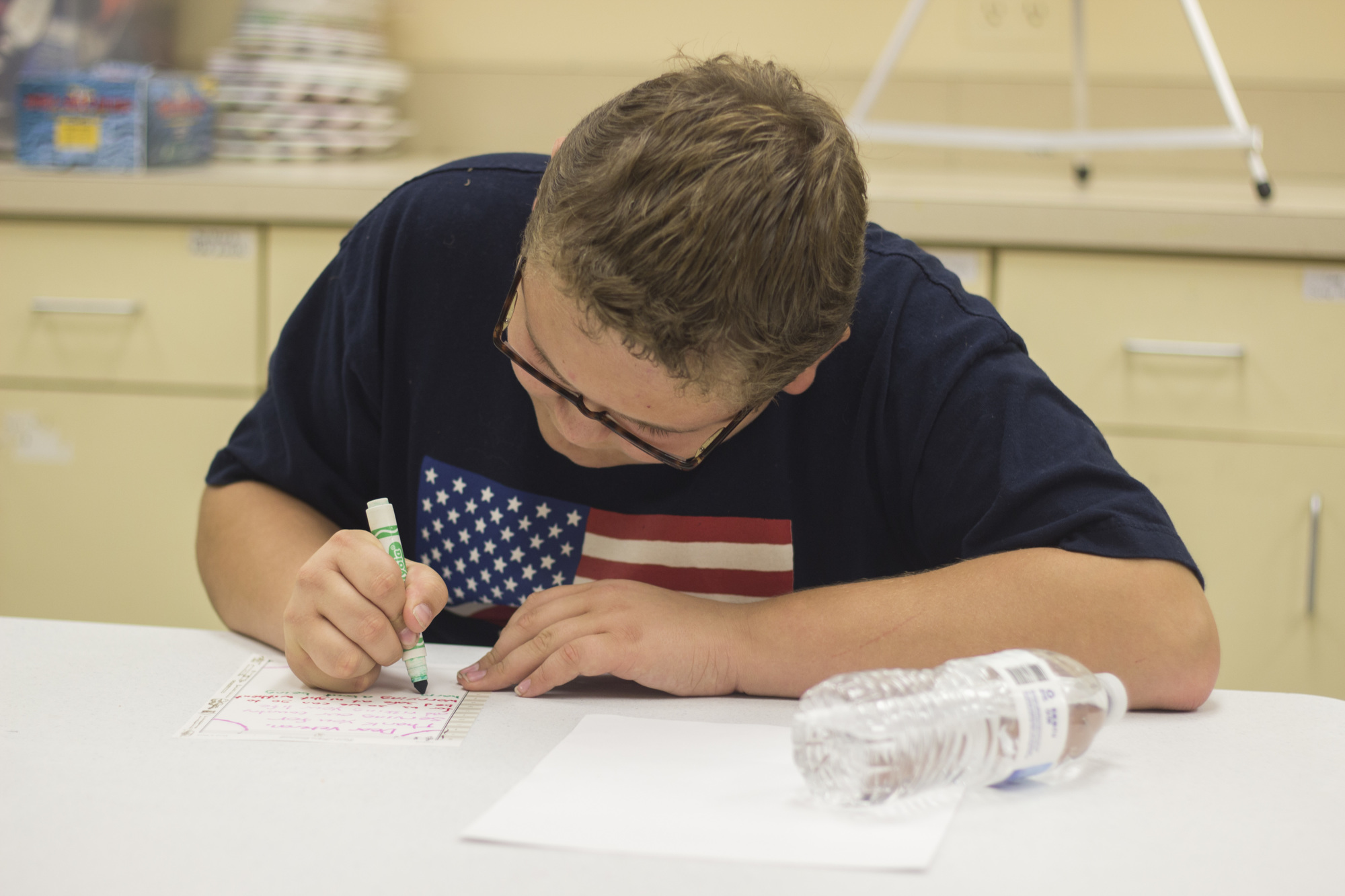 Byron Stull, 13, writes a letter of gratitude to a local veteran.