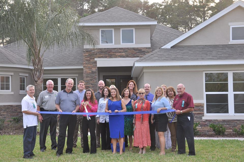 The Chamber of Commerce held a ribbon cutting for a housing development in Hunter’s Ridge. Shown with scissors is Sales Consultant Laura Hains. To her right is Tim Burkin, director of sales. Courtesy photo