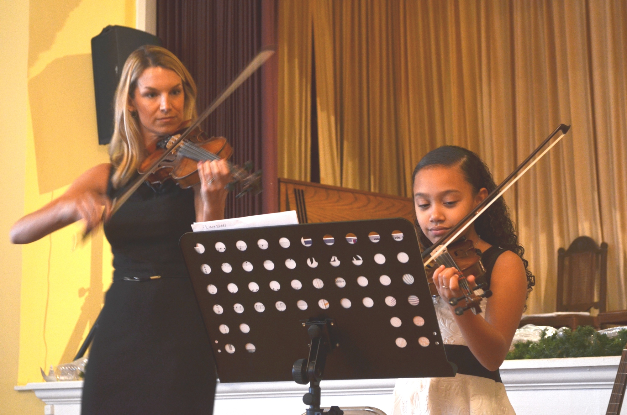 Melanie Nordstrom plays a duet with her student, Andreya Bridger.