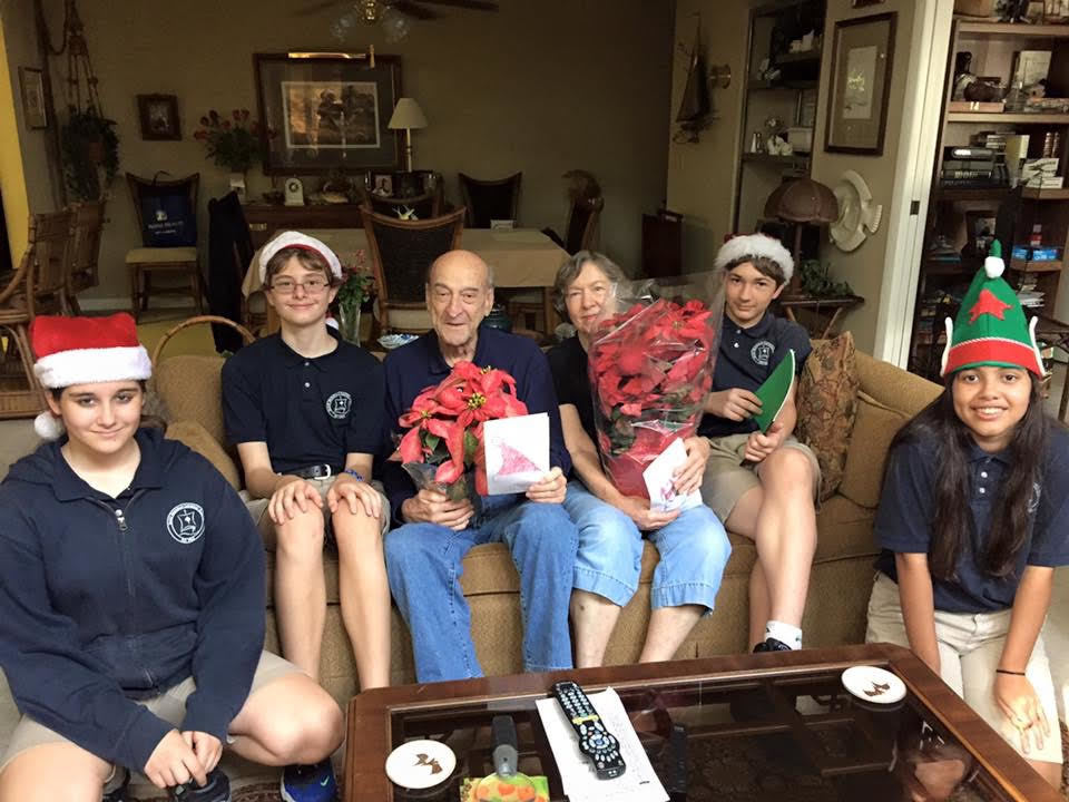 For the 13th year, Lizanne Swaringen's eighth-grade class delivered poinsettias and hand-made cards to the home-bound of Ormond Beach. Left to right: Alicea Roshio, Trevor Tobey, Paul Badovick, Dot Badovick Otto Weston and Anamaria Alonso (Courtesy photo)
