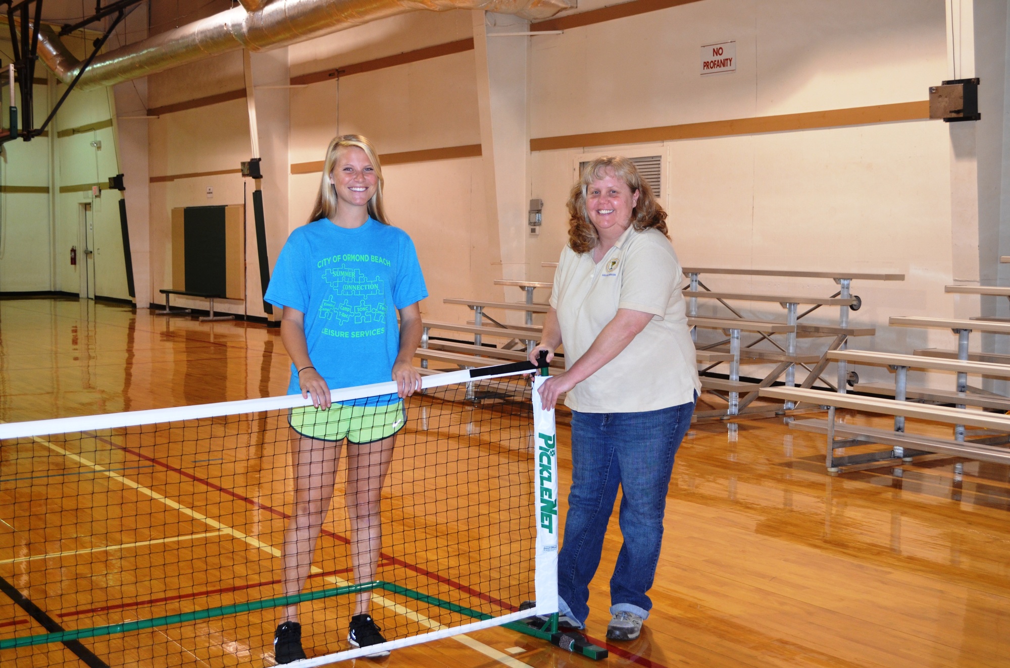 Getting the pickle ball net ready are recreation assistant Kacie Walker and Lori Koplin, Nova Recreation Center coordinator.