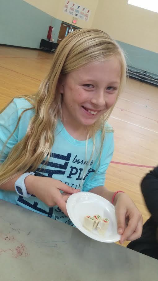 Emily Glass enjoying a healthy snack at the Ormond Beach Family YMCA Cooking Club Enrichment Program (Courtesy photo).