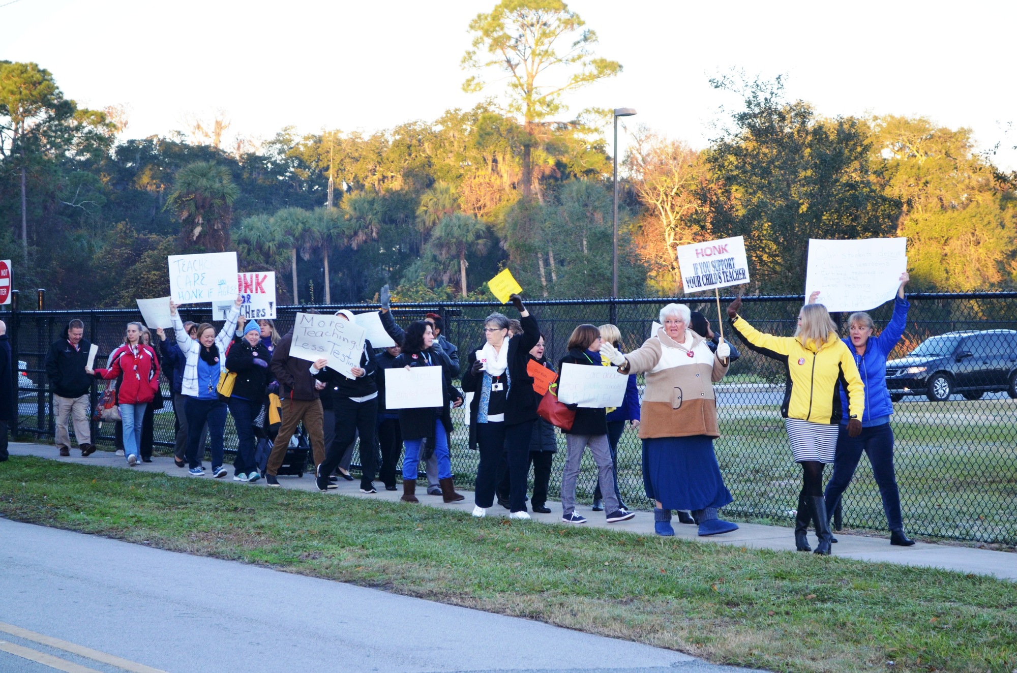 Teachers demonstrate unity in their contract negotiations in a “walk-in” at Holly Hill School.