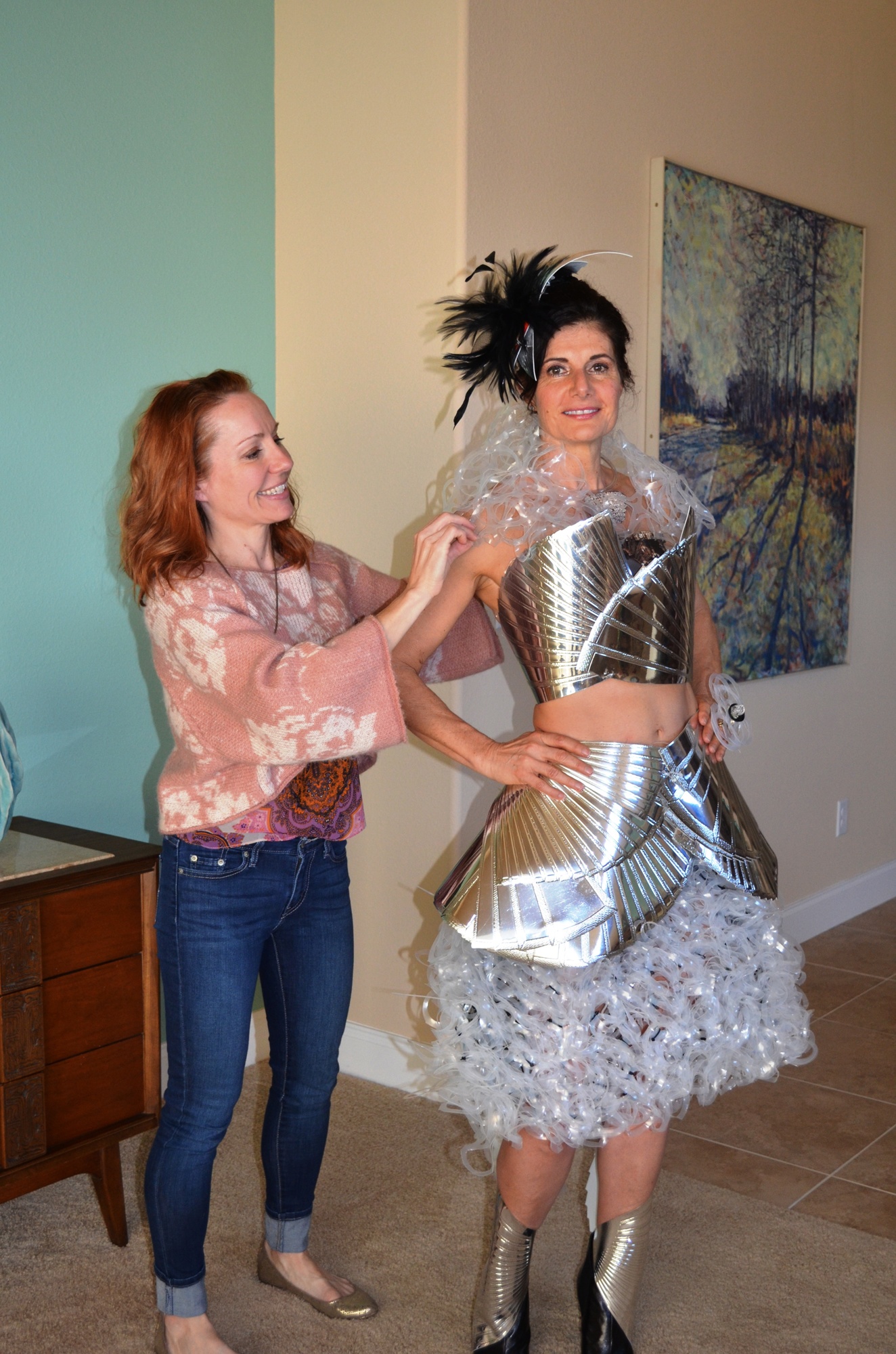 Trash 2 Trends designer Gail Warner and model Laura Greer show a dress on a runway.