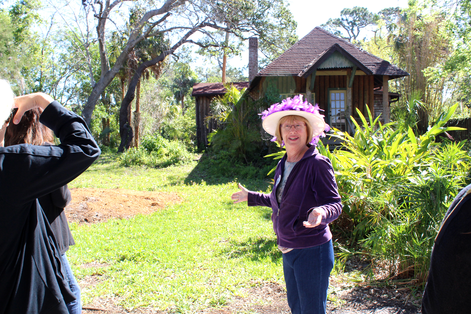 Joyce Benedict of the Ormond Beach Historical Society shows the leadership class a 1905 Palm log cabin. Photo by Jacque Estes