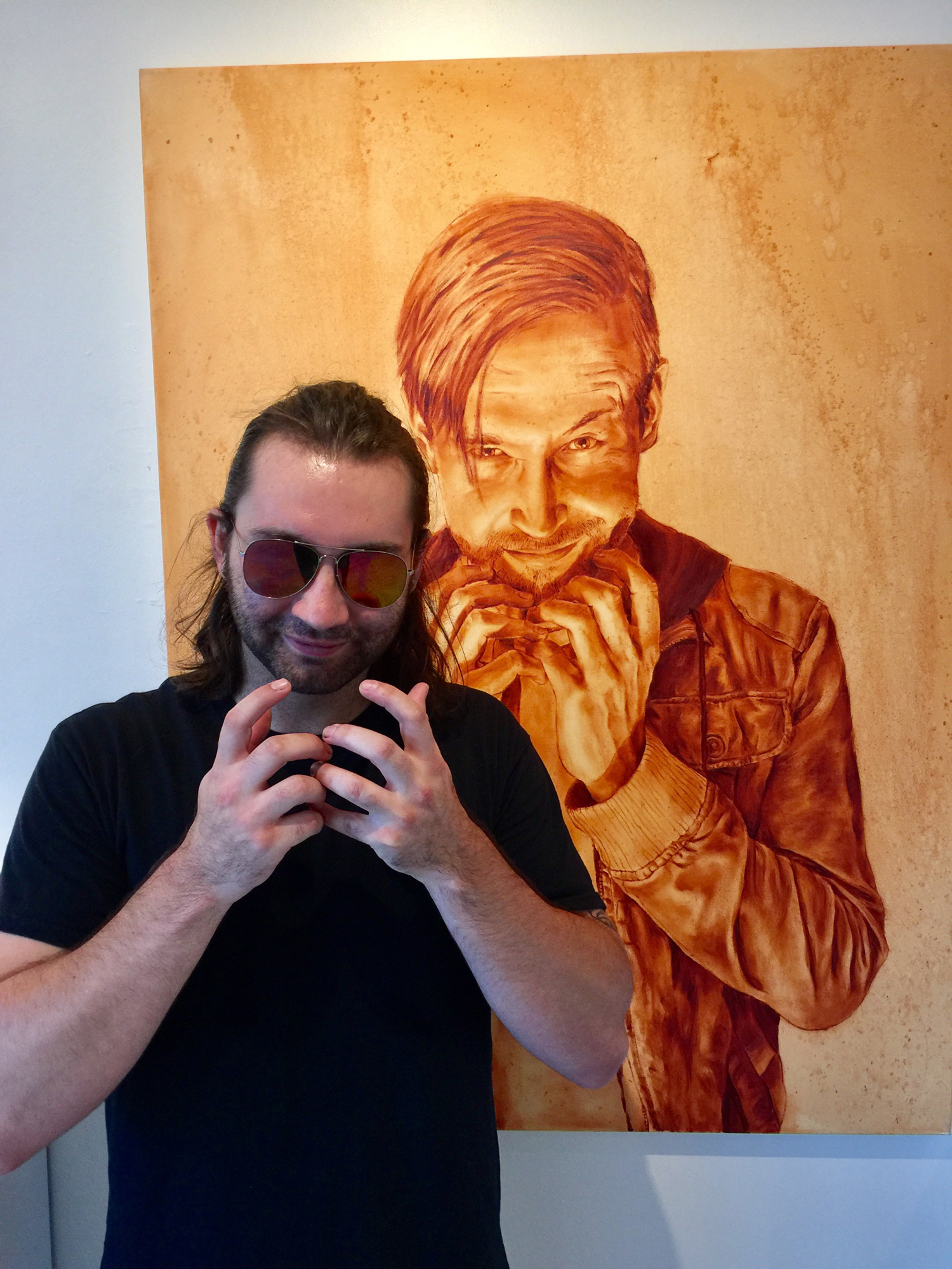 Jeremy Pappa poses in front of one of his portraits, at Arts on Granada on Wednesday, Sept. 13. Photo courtesy of Alice Gipson