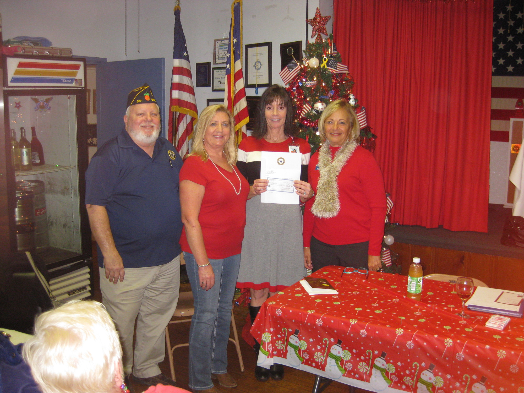 Post Commander Jim Bowers, Event Chairperson Linda Blanco, Carol Rumer, from Florida Hospital and Auxiliary President Carol Stauffer at the check presentation. Photo courtesy of the American Legion Auxiliary Post no. 267