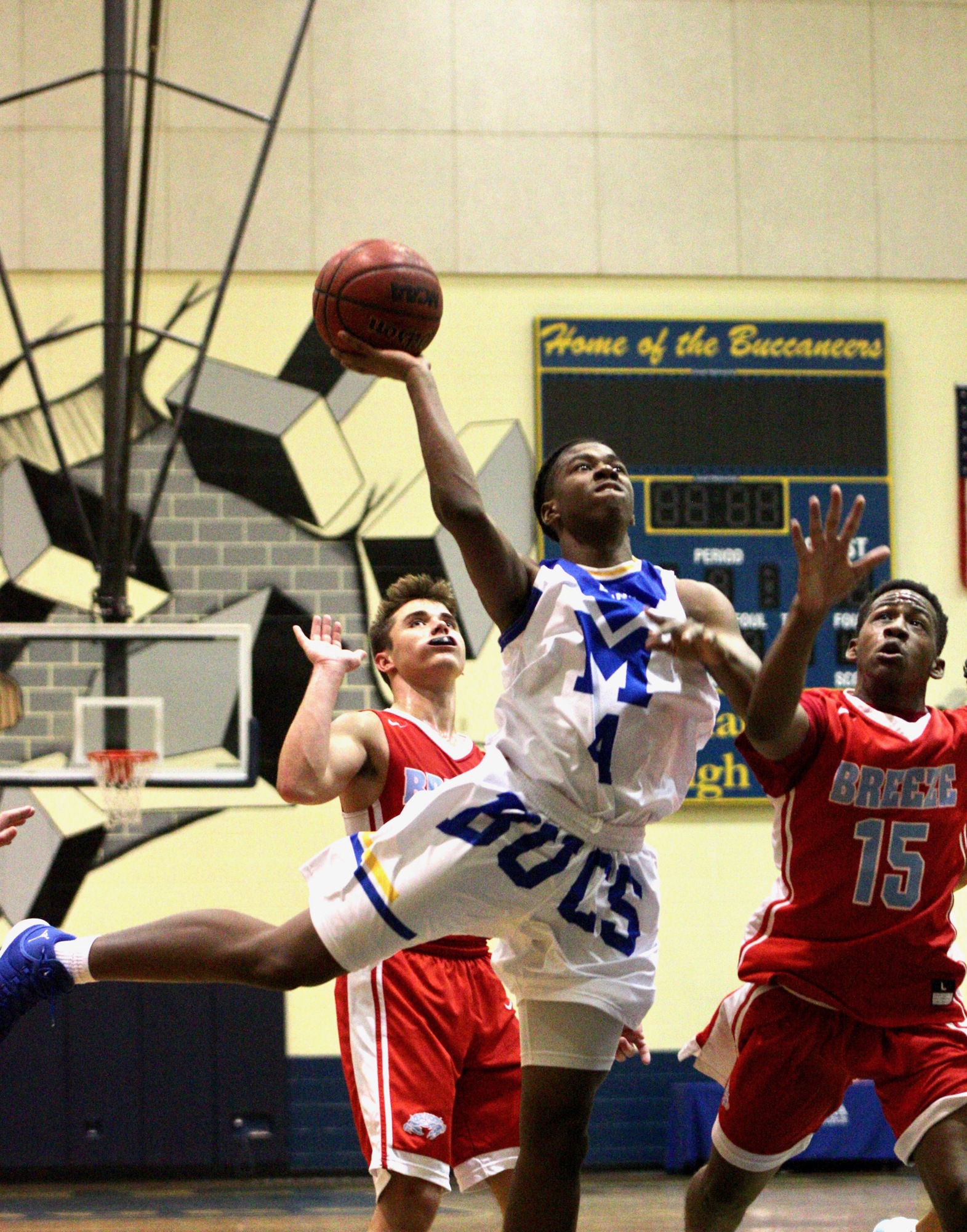 Mainland's Joe Jackson attempts a layup against Seabreeze. Photo by Ray Boone