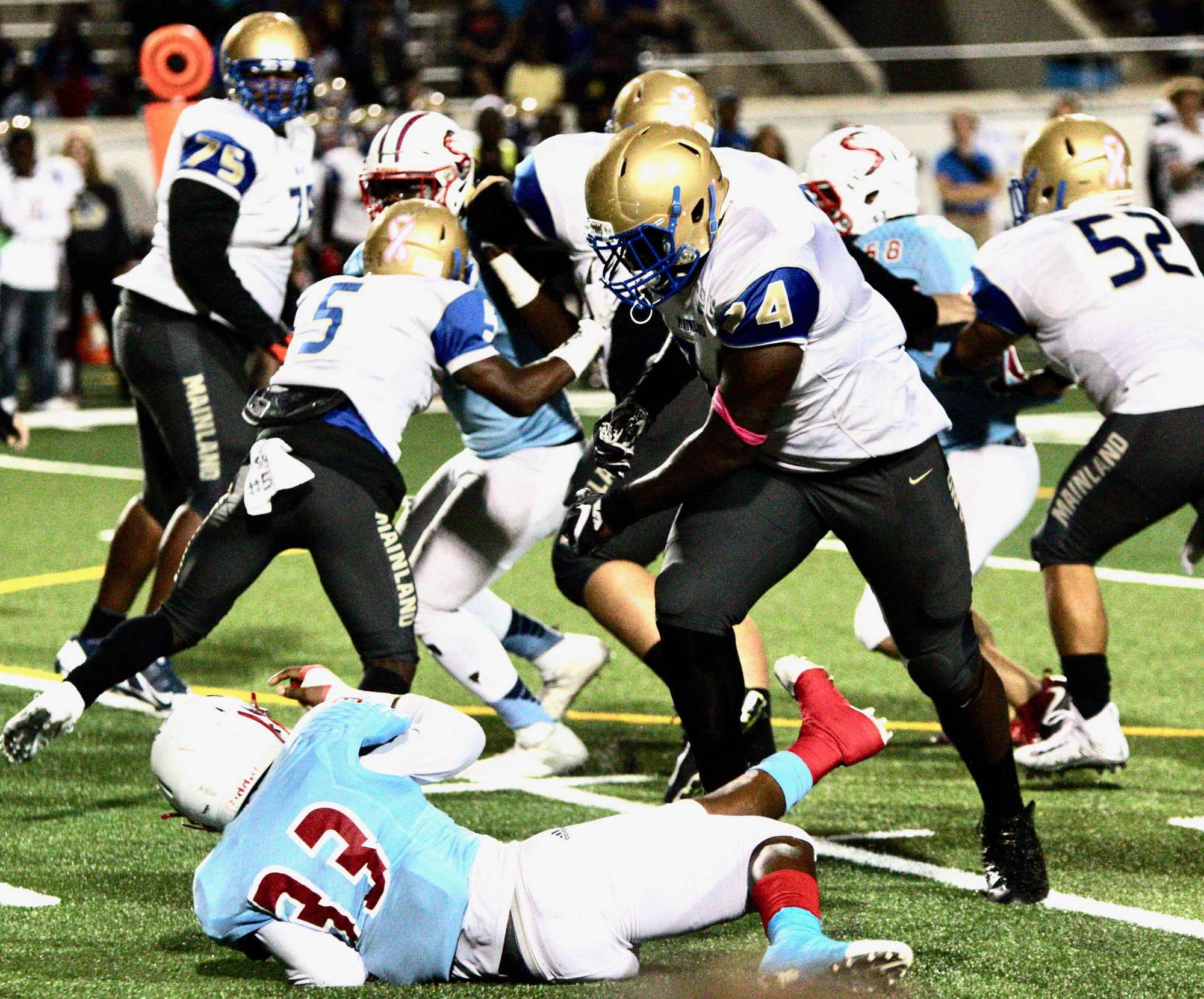 Mainland offensive lineman Adonis Boone throws down a defender. File Photo