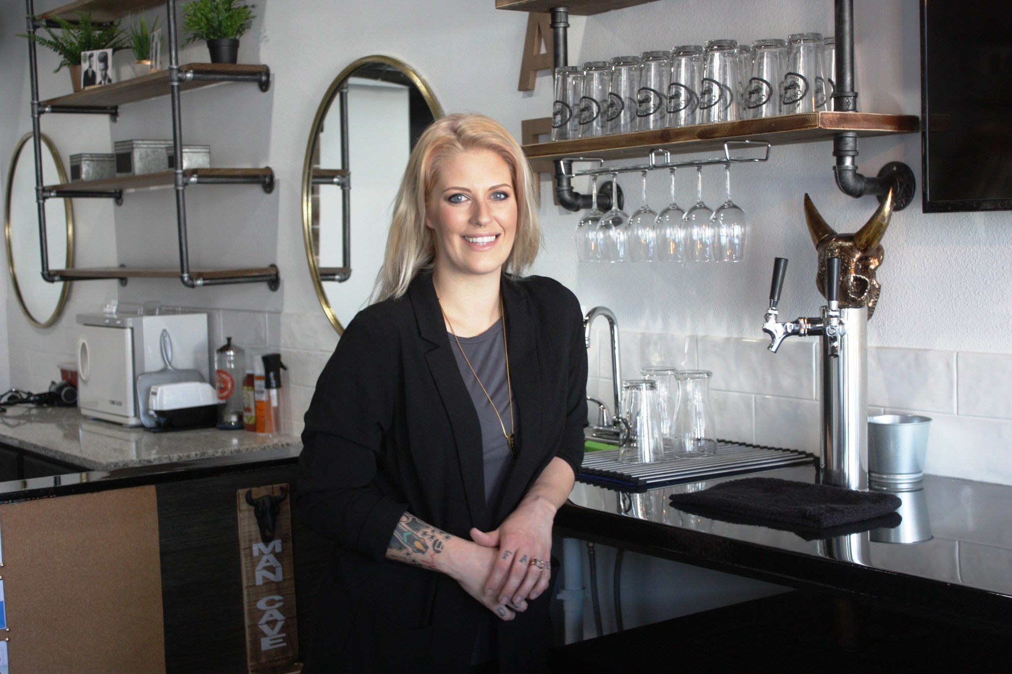 Ashly Rose, owner/stylist at Doll Face Hair Finery, has opened the Men’s Refinery, a salon for men where craft beer is also sold. Photo by Wayne Grant