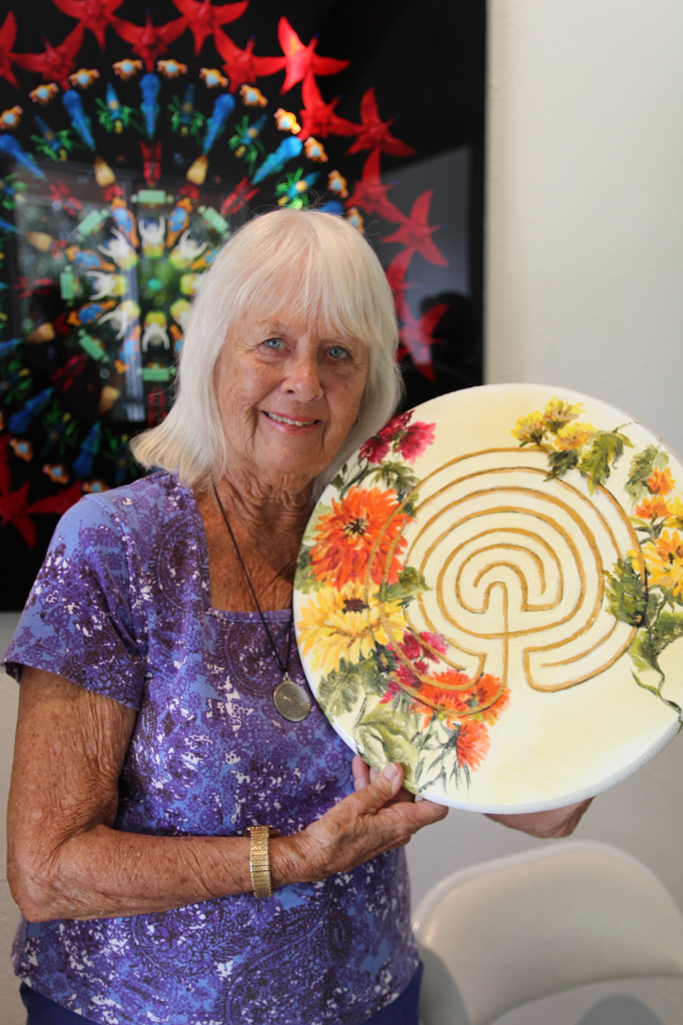 Joan Baliker smiles with a finger labyrinth inside OMAM on Feb. 24. Photo by Jarleene Almenas