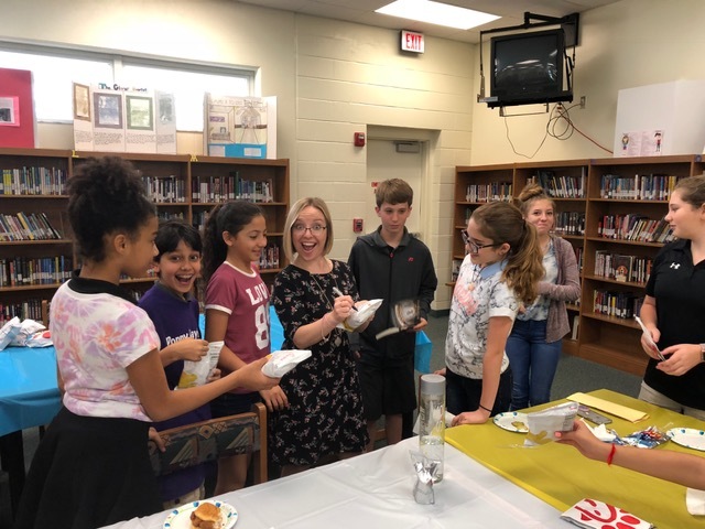 Jennie K. Brown signs items for Hinson Middle School students. Courtesy photo.