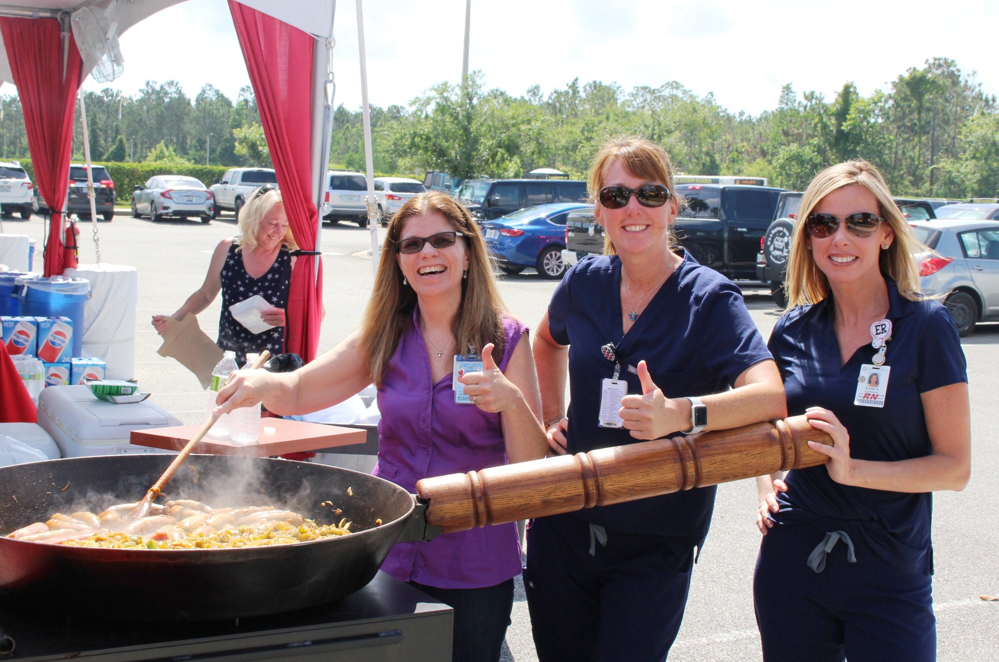 Florida Hospital Memorial Medical Center hosted a free barbecue for emergency responders. Shown are emergency department team members Mary Uanino, Kathleen Krier and Nancy Kimpton helping to prepare the food.