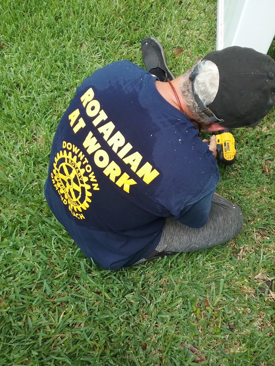 A Rotary Club member works on a local 92-year-old widow's fence in Ormond Beach. Courtesy photo