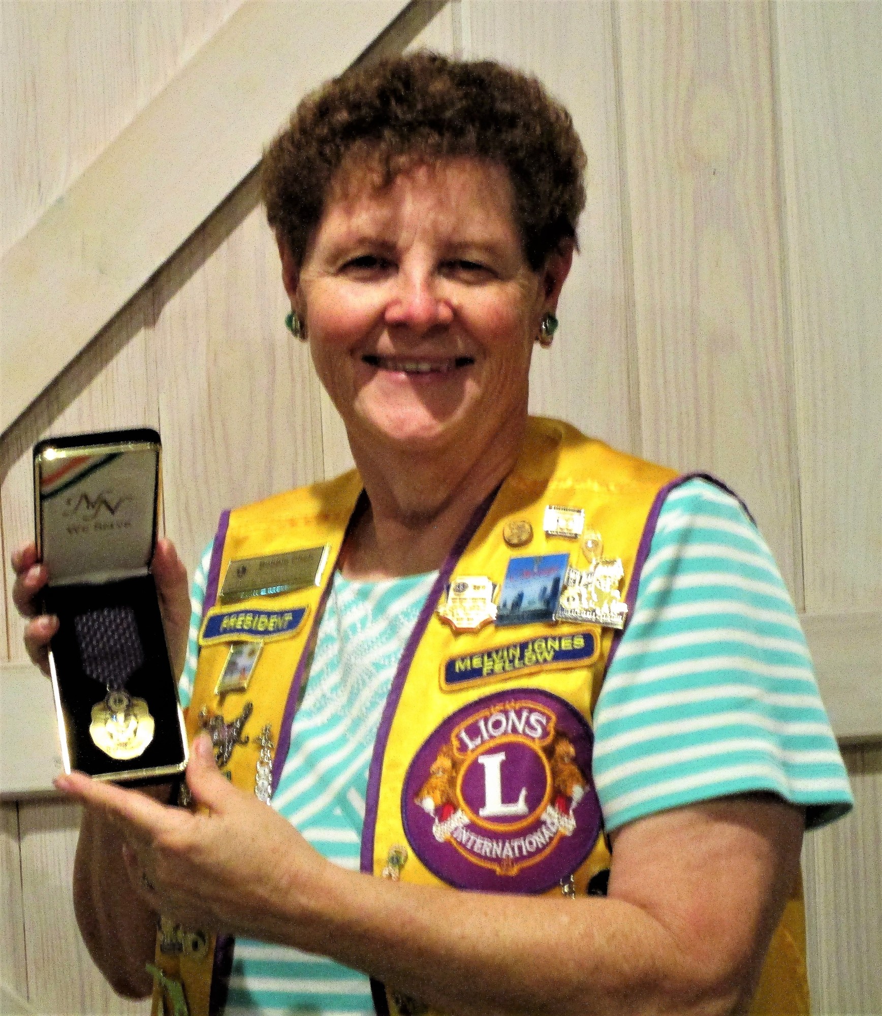Lion Bobbie Cheh with the Lions Club International President Dr. Naresh Aggarwal's President's Award. Courtesy photo