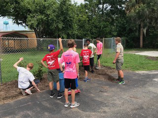 Boy Scout Troop 403 helps clean up the exterior of the Pace Center for Girls in Ormond Beach. Courtesy photo