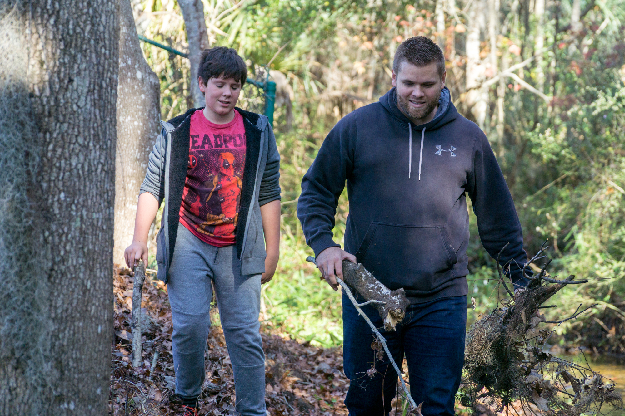 Skip helps Liam gather wood in order to make a bridge across the creek