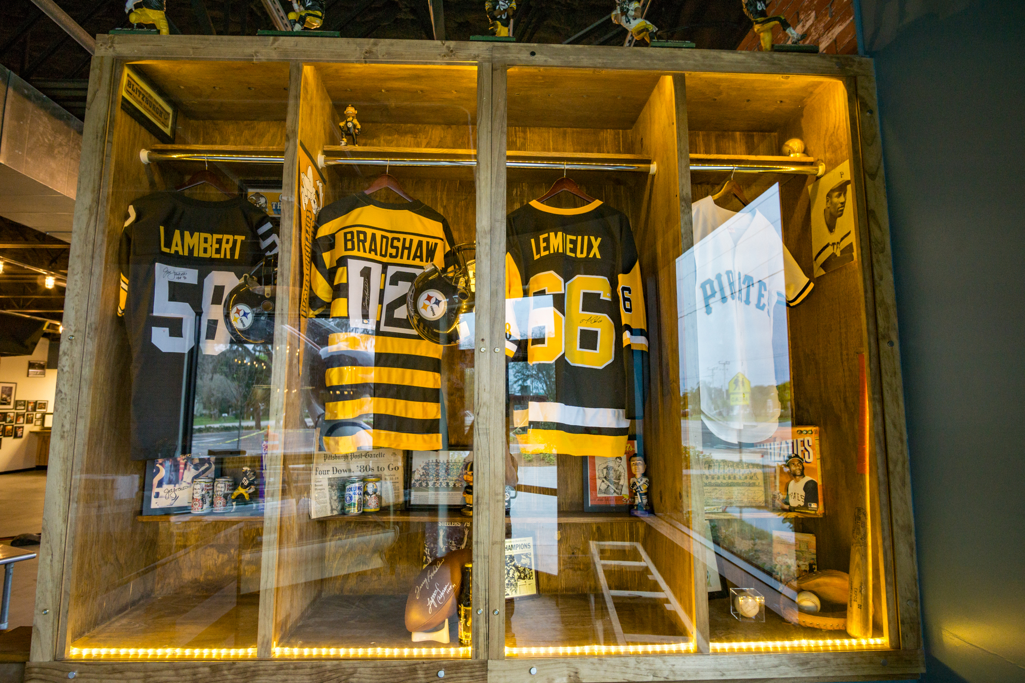Giuseppe's Steel City Pizza is featuring a custom built locker-style display case with high school football jersey's from the Pittsburg area. Photo by Zach Fedewa