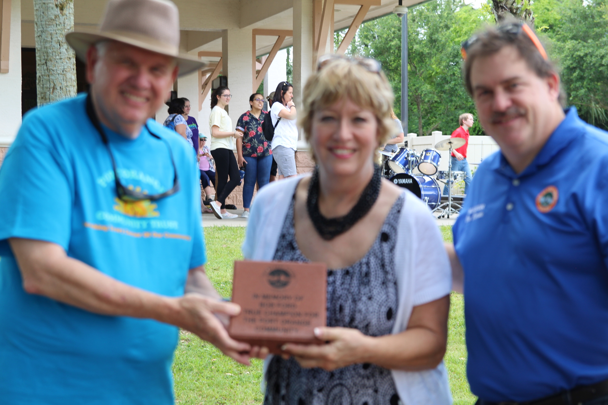 Former City Manager, Ken Parker, Marilyn Ford, and Mayor, Don Burnette hold the brick presented in Bob Ford's honor. Photo by Tanya Russo