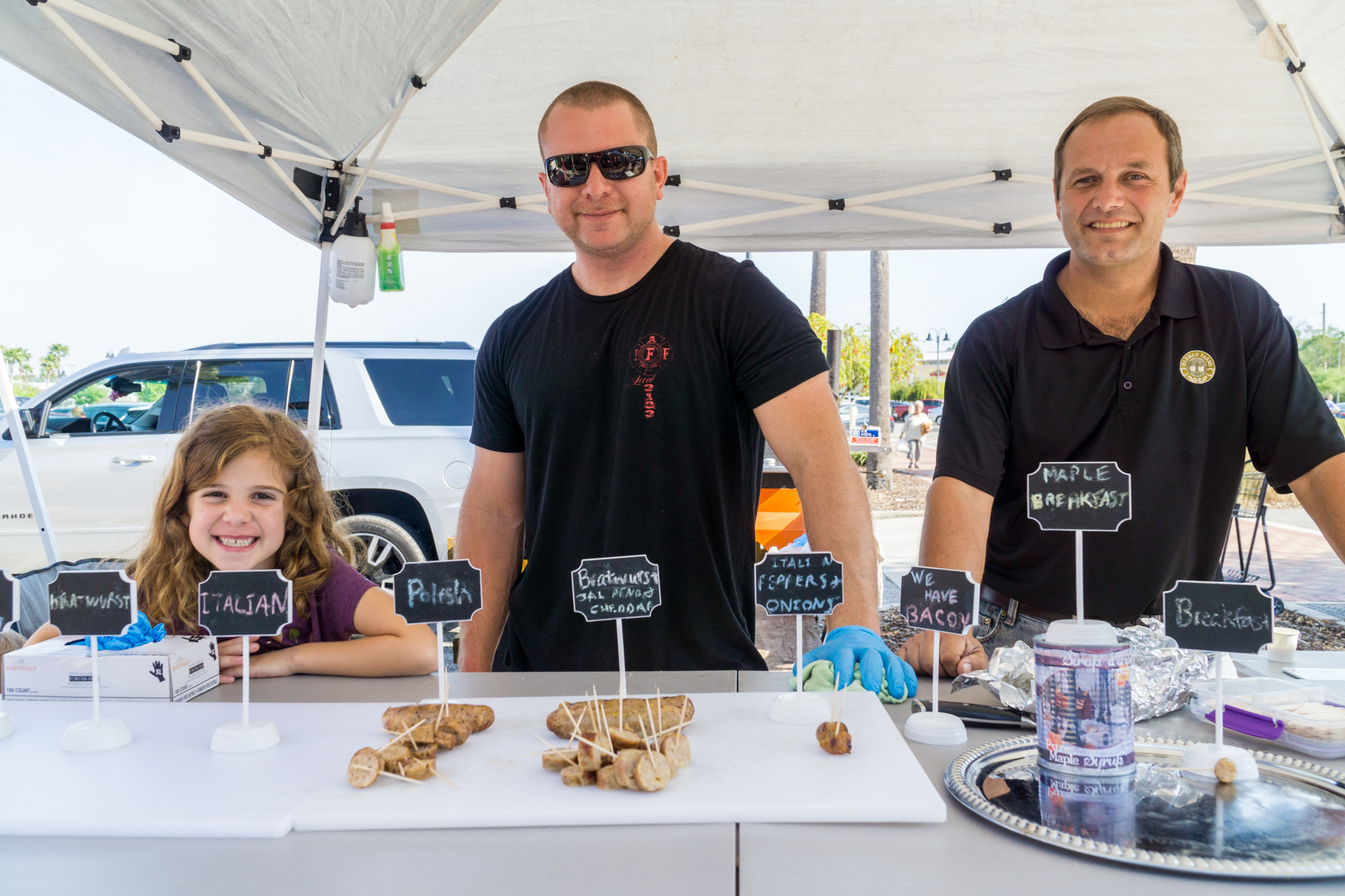 Emma Taylor, Jason Taylor, and Zachary Harman represent Harman Farms at the farmers market in the Pavilion in Port Orange. Photo by Zach Fedewa