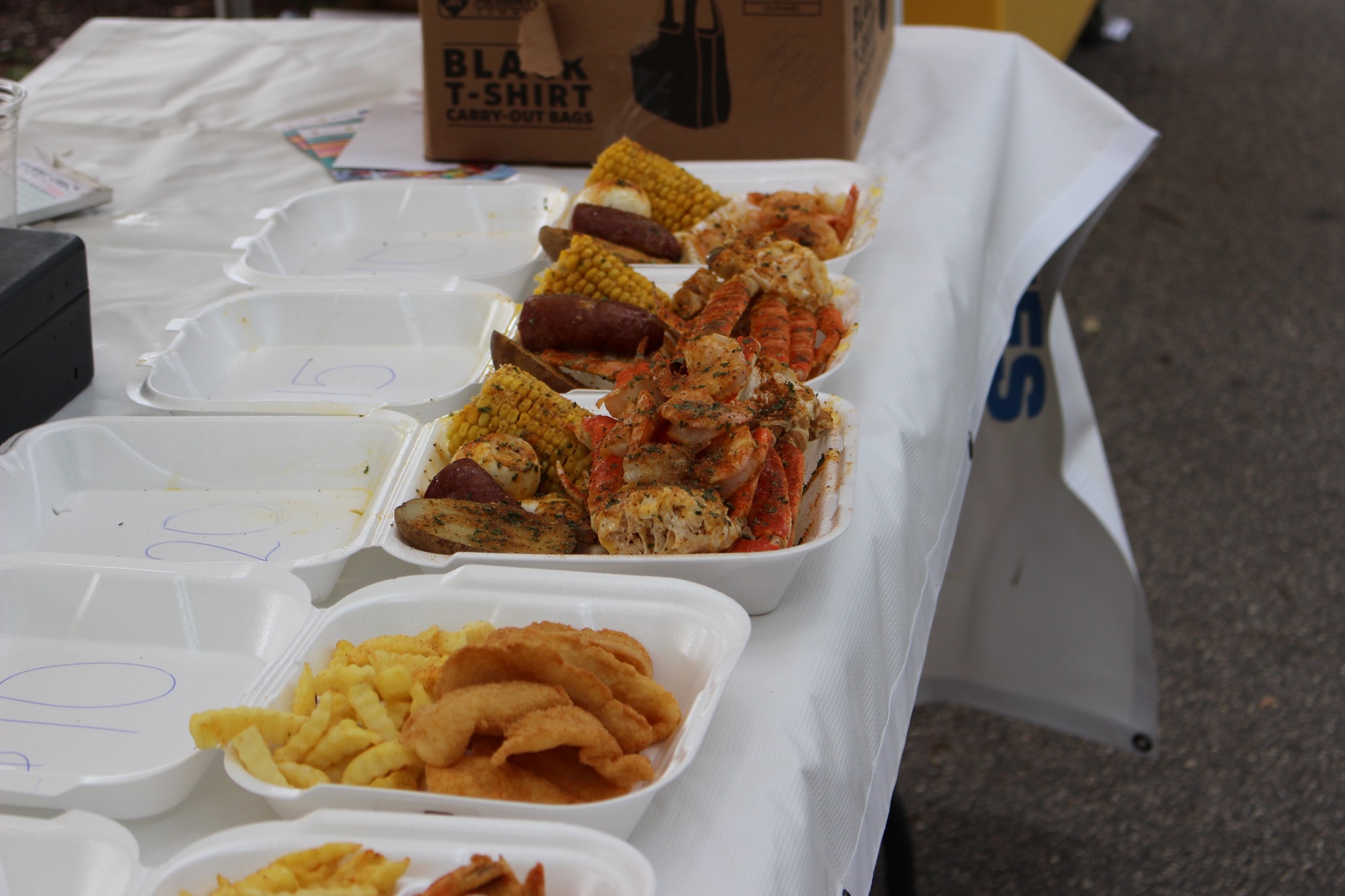 Plates ready for pick up at the 3 Kings Catering food truck at the Fourth-Annual Crab and Seafood Festival on Saturday, July 13. Photo by Alyssa Warner