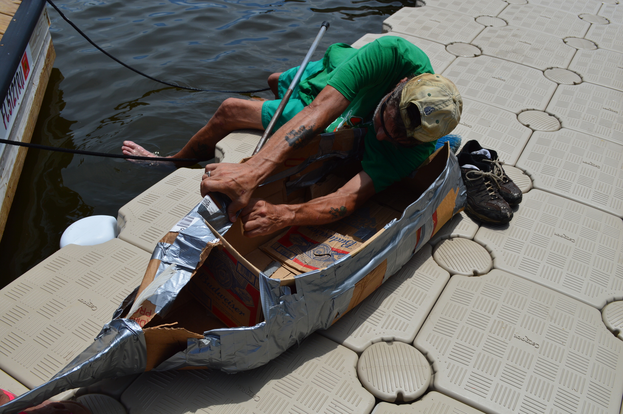B.J. Devine, of South Daytona, fixes his cardboard boat before the race began. Photo by Caroline Smith