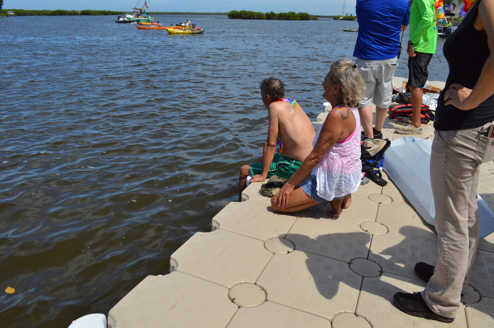 B.J. Devine and Renee Dodick eagerly watch the race from the dock. Photo by Caroline Smith