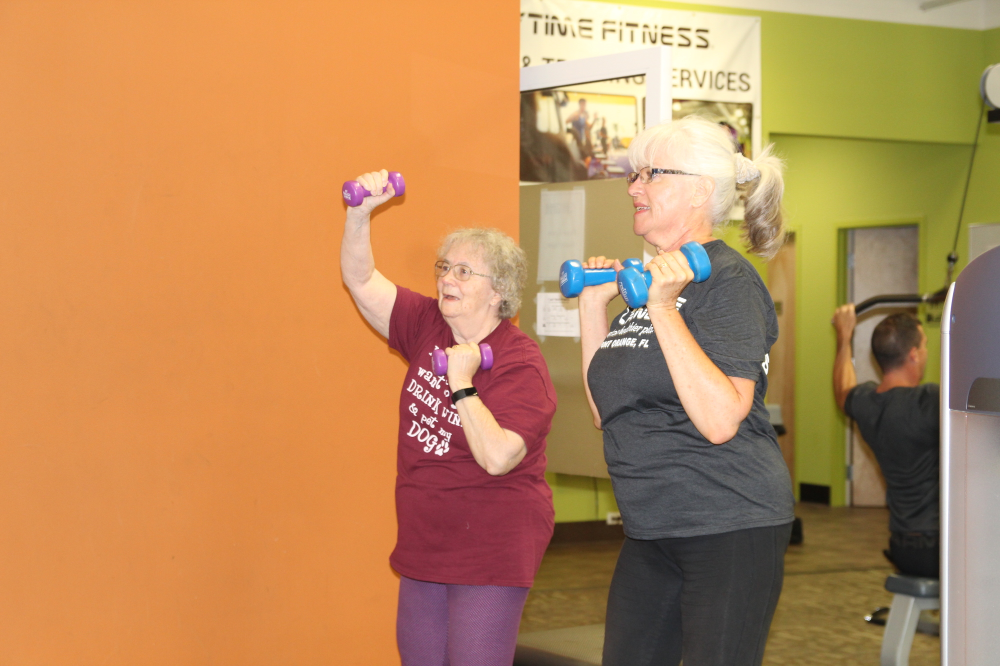 Joyce Snodgrass and Marilyn Pantera lift weights for resistance and range of motion. Photo by Tanya Russo
