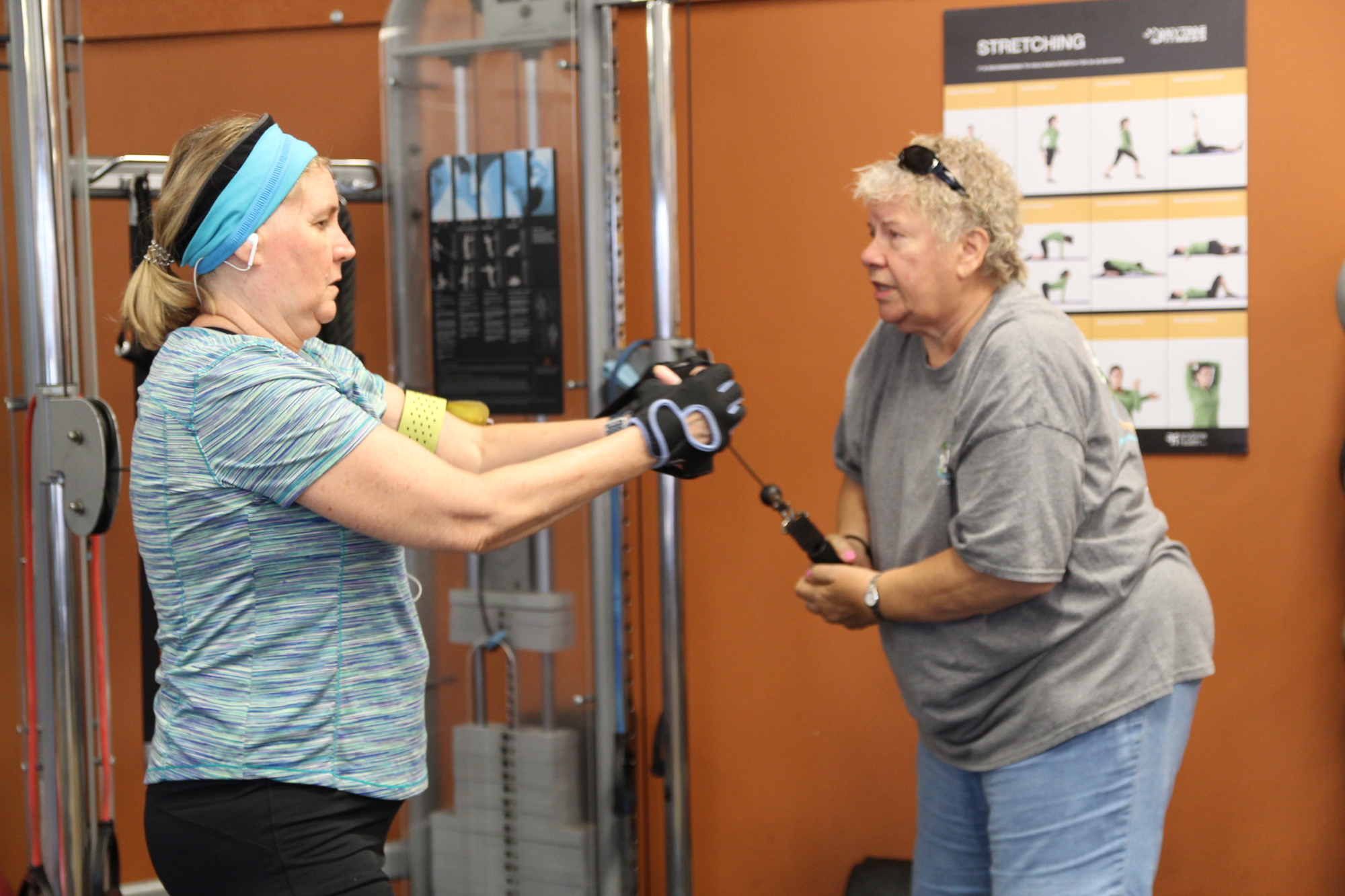 Renee Chisholm and Grace Devoe work on strength resistance as part of Ageless Fitness. Photo by Tanya Russo